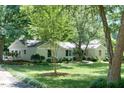 Charming single-story home with a meticulously landscaped front yard and mature trees at 9 Kimberly Dr, Durham, NC 27707