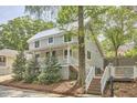 Charming two-story home with a metal roof, inviting front porch, and well-manicured landscaping at 918 Orient St, Durham, NC 27701
