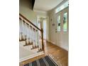 Inviting foyer features hardwood floors, decorative glass door, and staircase with wooden banister at 1002 Springmill Ct, Apex, NC 27502