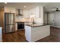 A modern kitchen with stainless steel appliances, a subway tile backsplash, and an island at 101 Pine St, Dunn, NC 28334