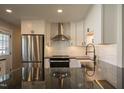 A modern kitchen featuring stainless steel appliances, black countertops, and a center island at 101 Pine St, Dunn, NC 28334