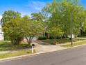 Street view of a brick home featuring a driveway and a meticulously maintained front yard at 107 Weslyn Trace Dr, Durham, NC 27703