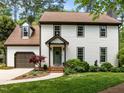 Charming two-story home with a landscaped front yard, attached garage and cozy covered entryway at 107 Whitby Ct, Cary, NC 27511