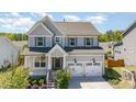 Charming two-story home with a covered front porch and attached two-car garage at 108 Sunburst Dr, Durham, NC 27705