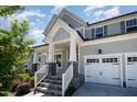 Covered front porch with stone accents and a view of the home's two-car garage at 108 Sunburst Dr, Durham, NC 27705