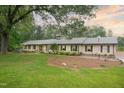 Charming brick home features a well-maintained lawn, mature trees, and a welcoming facade with dark green shutters at 11 Pine Forest Dr, Siler City, NC 27344
