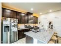 Modern kitchen featuring dark cabinetry, granite countertops, and stainless steel appliances at 1108 Orchard Stream Dr, Haw River, NC 27258