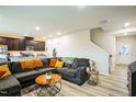 Inviting living room adjacent to the kitchen, featuring a comfortable couch and staircase at 1108 Orchard Stream Dr, Haw River, NC 27258