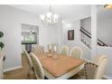 Elegant dining room with chandelier lighting, hardwood floors, and views into the living spaces at 1305 Montreux Ct, Mebane, NC 27302
