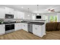 Bright kitchen with white cabinets, modern appliances, stainless steel dishwasher, and durable countertops at 1305 Montreux Ct, Mebane, NC 27302