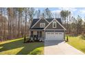 Charming two-story home with symmetrical roofline, white trim, and two car garage at 145 Leisure Ln # 12, Louisburg, NC 27549