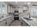 Elegant kitchen featuring granite counters, stainless appliances, and light gray cabinets at 145 Leisure Ln # 12, Louisburg, NC 27549