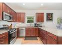 A well-equipped kitchen with stainless steel appliances and wood cabinets provides a delightful cooking experience at 150 Sherrill Place Ln, Garner, NC 27529