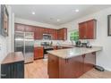 Bright kitchen features wood floors, a granite-topped island and matching countertops with stainless steel appliances at 150 Sherrill Place Ln, Garner, NC 27529
