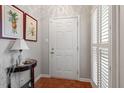 Bright entryway featuring parquet floors, white door, and elegant decor at 1601 Dunraven Dr, Raleigh, NC 27612