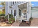 Close up of front porch featuring house number, black door, and brick pathway at 1601 Dunraven Dr, Raleigh, NC 27612