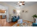 Comfortable living space with blue sofa, patterned rug, hardwood floors, and natural light, creating a cozy and inviting atmosphere at 200 Wood Hollow Dr, Cary, NC 27513