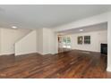 Open concept living room features hardwood floors, neutral walls, fireplace, and access to kitchen at 2024 Spring Creek Dr, Durham, NC 27704