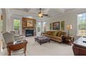 Inviting living room features a stone fireplace, coffered ceilings, and lots of natural light at 2053 Monthaven Dr, Wake Forest, NC 27587