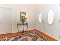 Inviting foyer featuring hardwood floors, a mirror, and a decorative rug, creating a warm welcome at 226 Marshview Cir, Angier, NC 27501