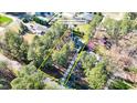 Aerial view of a lovely home surrounded by mature trees, offering privacy and a serene setting at 2418 Mont Haven Dr, Durham, NC 27712