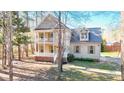 Charming two-story home featuring a welcoming porch, double balconies, and nicely landscaped front yard at 2418 Mont Haven Dr, Durham, NC 27712