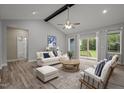 Bright living room with vaulted ceiling, ceiling fan, and sliding glass doors to the backyard deck at 25 Leisure Ln # 2, Louisburg, NC 27549