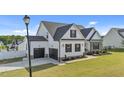 Beautifully designed two-story home with a spacious three-car garage and a well-maintained front lawn at 30 Devilwood Dr, Four Oaks, NC 27524