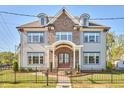 Charming two-story home with a mix of brick and siding, dormer windows, and a well-manicured front yard at 301 Georgetown Rd, Raleigh, NC 27608