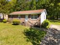 Quaint brick home features a well-maintained front yard, mature trees, and inviting entrance stairs at 3016 Fields Dr, Raleigh, NC 27603