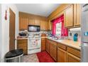 Functional kitchen with oak cabinetry, a window over the sink and essential appliances at 3016 Fields Dr, Raleigh, NC 27603