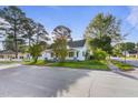 Charming home exterior showcasing its architectural style, surrounding trees, and well-maintained landscape at 302 N Sumner St, Selma, NC 27576