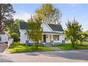Classic home featuring a welcoming front porch, lovely landscaping, and inviting curb appeal at 302 N Sumner St, Selma, NC 27576