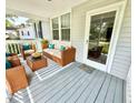 Relax on this cozy front porch with wicker furniture, perfect for enjoying the outdoors at 309 19Th St, Butner, NC 27509
