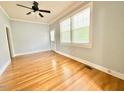 Spacious living area with beautiful hardwood floors, lots of natural light, and a ceiling fan at 309 19Th St, Butner, NC 27509