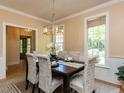 Bright dining room featuring a modern chandelier and stylish decor at 315 King George Loop, Cary, NC 27511