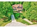 Aerial view of a beautiful home surrounded by lush greenery and mature trees, with a long driveway at 3581 Boulder Ct, Wake Forest, NC 27587