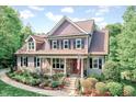 Beautiful two-story home with manicured landscaping, a stone-accented porch, and classic shutters at 3581 Boulder Ct, Wake Forest, NC 27587