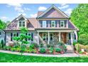 Inviting two-story home with a stone-accented porch and colorful landscaping, creating a warm curb appeal at 3581 Boulder Ct, Wake Forest, NC 27587