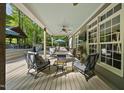 Covered patio with comfortable seating, ceiling fan, and view of the pool and outdoor kitchen at 359 Heather Bluffs Dr, Garner, NC 27529