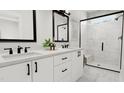 Bright bathroom with double vanity, modern fixtures, and glass-enclosed shower with marble tiling for a luxurious feel at 3926 Lost Fawn Ct, Raleigh, NC 27612