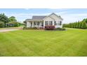 Charming one-story home featuring a covered front porch, black shutters, and a well-manicured lawn at 40 Senter Farm Ct, Fuquay Varina, NC 27526