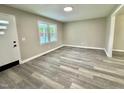 Bright living room featuring gray toned floors, neutral walls, and a large window that fills the room with light at 42 S 2Nd St, Roxboro, NC 27573