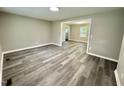 Spacious living room featuring gray toned floors and a glimpse into the kitchen area at 42 S 2Nd St, Roxboro, NC 27573