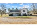 View of home's rear exterior featuring a screened porch, and expansive yard at 4208 Louisbury Rd, Wake Forest, NC 27587