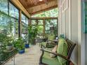 Inviting sunroom with walls of windows and comfortable seating at 4210 Falls River Ave, Raleigh, NC 27614