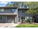 Charming townhome features a gray exterior, attached garage, and mature landscaping at 4318 Hunters Club Dr, Raleigh, NC 27606