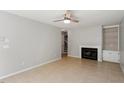 Bright living room with fireplace, built-in shelving, and tile flooring at 4318 Hunters Club Dr, Raleigh, NC 27606