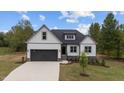 Charming new construction home featuring a two-car garage, stone accents and lush landscaping at 45 Leisure Ln # 4, Louisburg, NC 27549