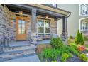 Inviting front porch featuring a cozy seating area with stylish decor and beautiful landscaping at 4816 Heathshire Dr, Raleigh, NC 27616